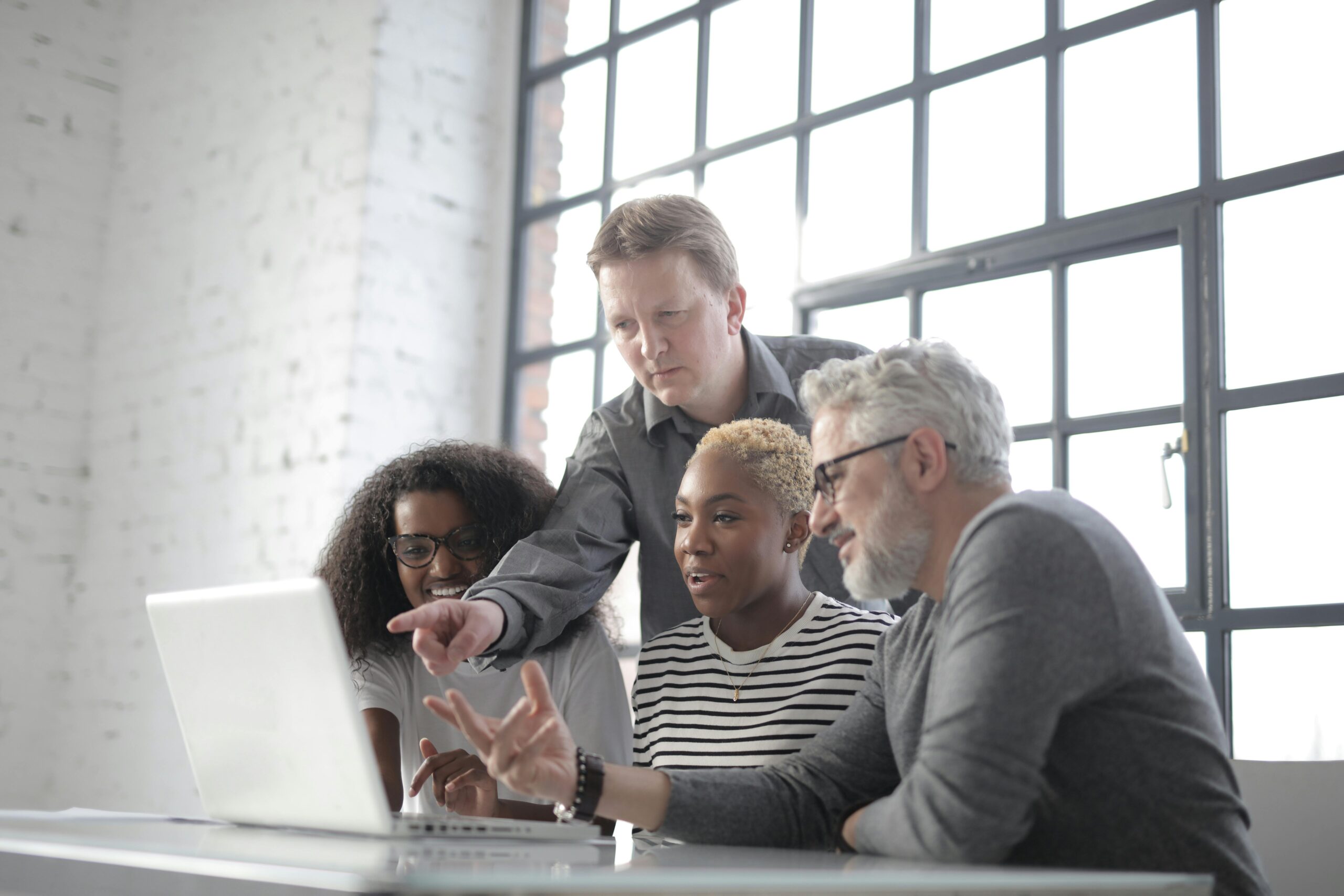 People collaborating in a modern workspace while learning and discussing artificial intelligence tools and technology.